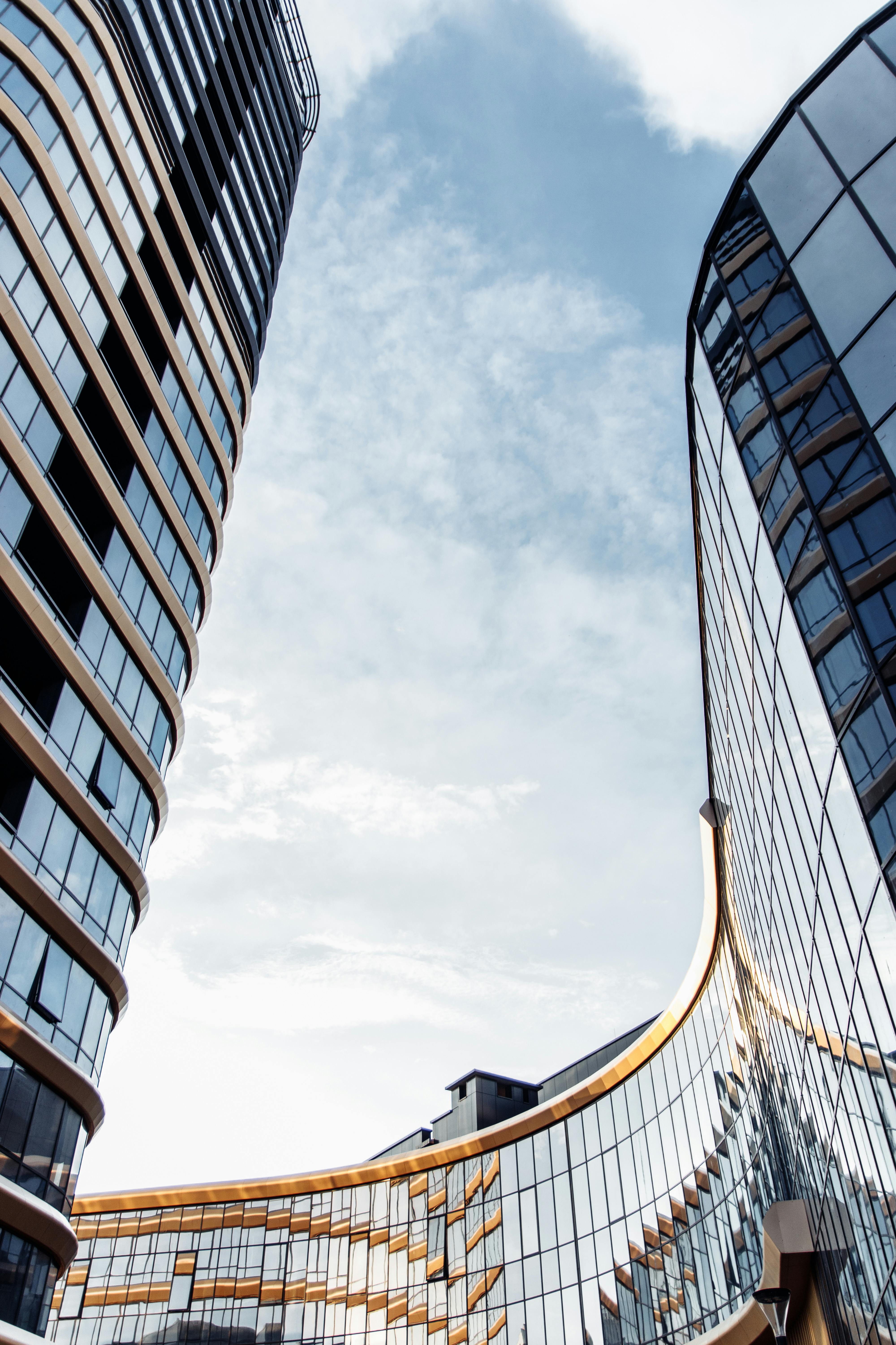 Sleek modern buildings reflecting in Minsk, Belarus against a blue sky.