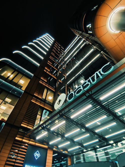 Free Low angle view of a stylish, illuminated modern building at night. Stock Photo