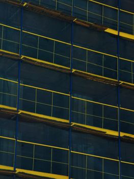 Close-up of scaffolding on a building under construction with geometric patterns.