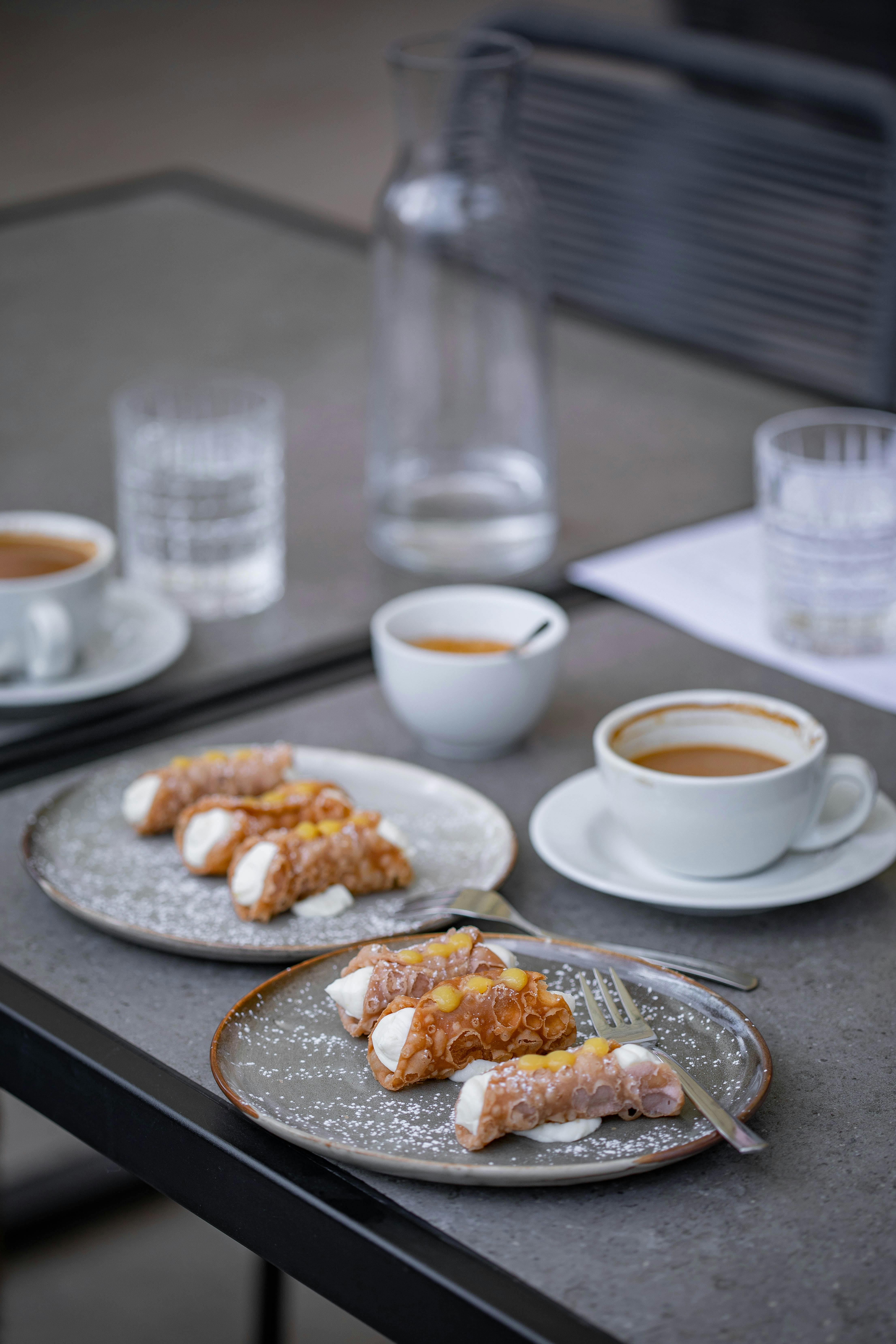 coffee cups and desserts on plates