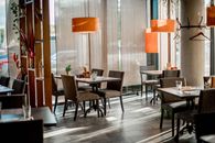 Cozy restaurant interior featuring elegant decor and warm lighting.