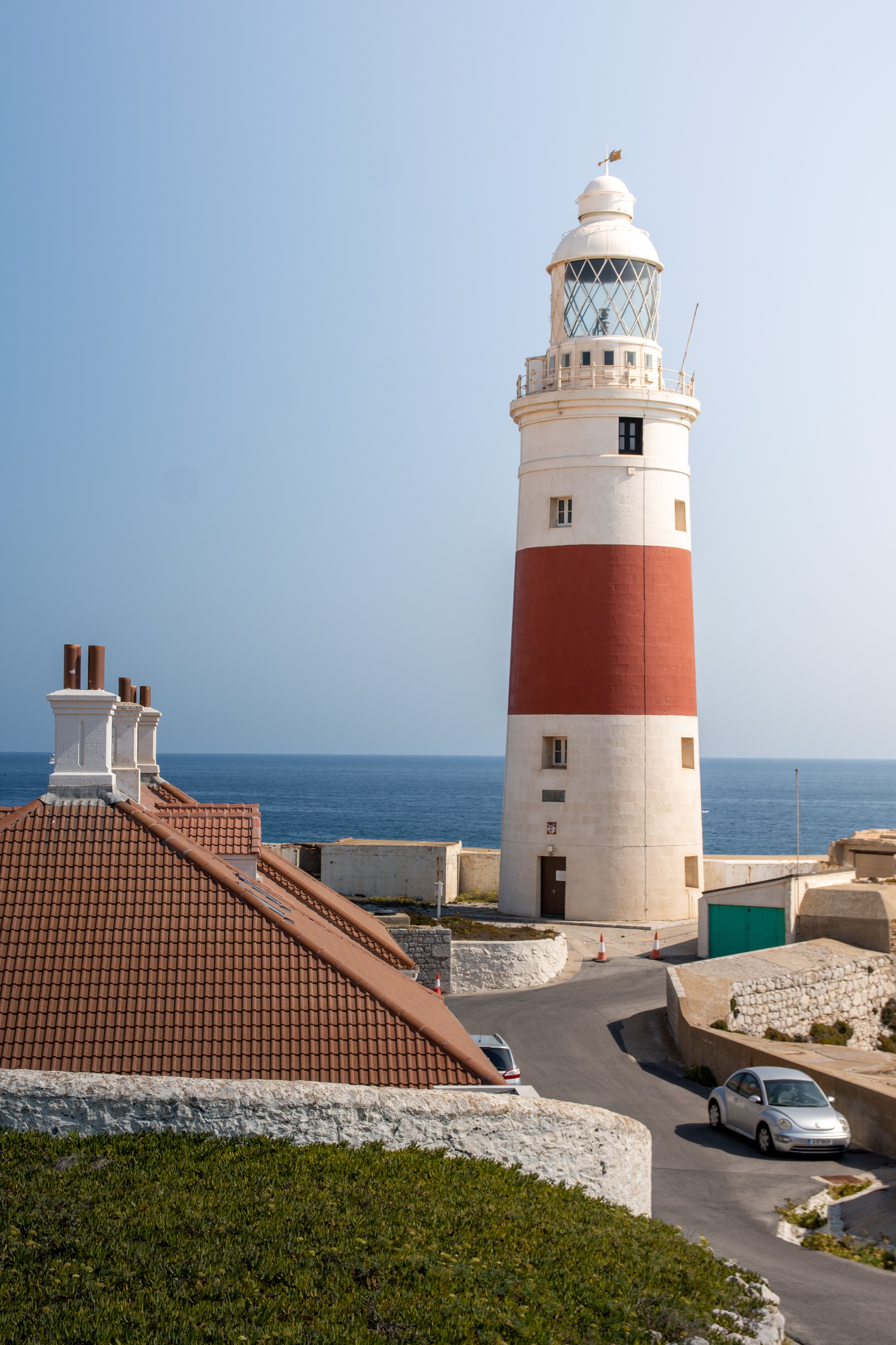 White and Red Lighthouse Near Body of Water · Free Stock Photo