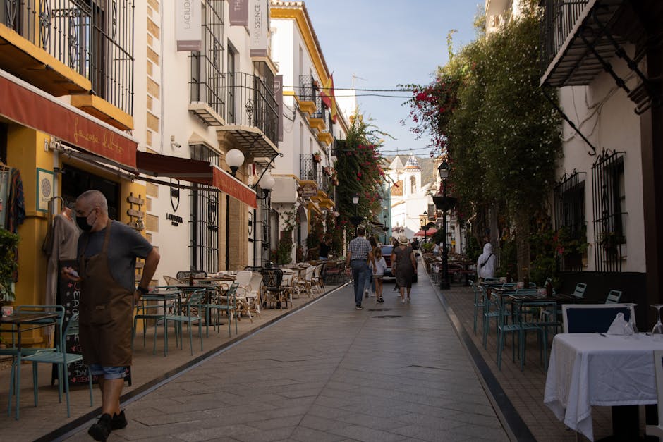 A bustling Auckland street scene with people dining at outdoor cafes.
