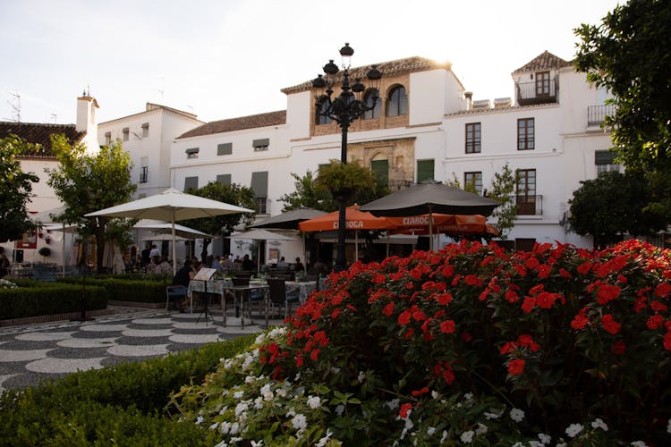 People Sitting Outside A Restaurant Garden Patio