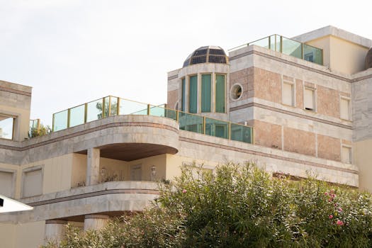 Contemporary architecture with glass balconies and decorative stone facade.