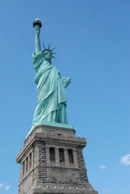 Free Iconic Statue of Liberty with a clear blue sky backdrop, symbolizing freedom. Stock Photo