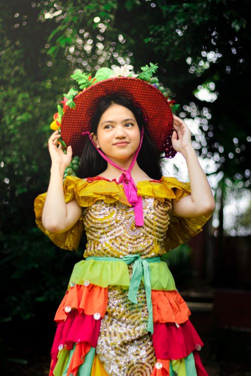 Free Vibrant portrait of an East Asian woman in colorful traditional attire outdoors. Stock Photo