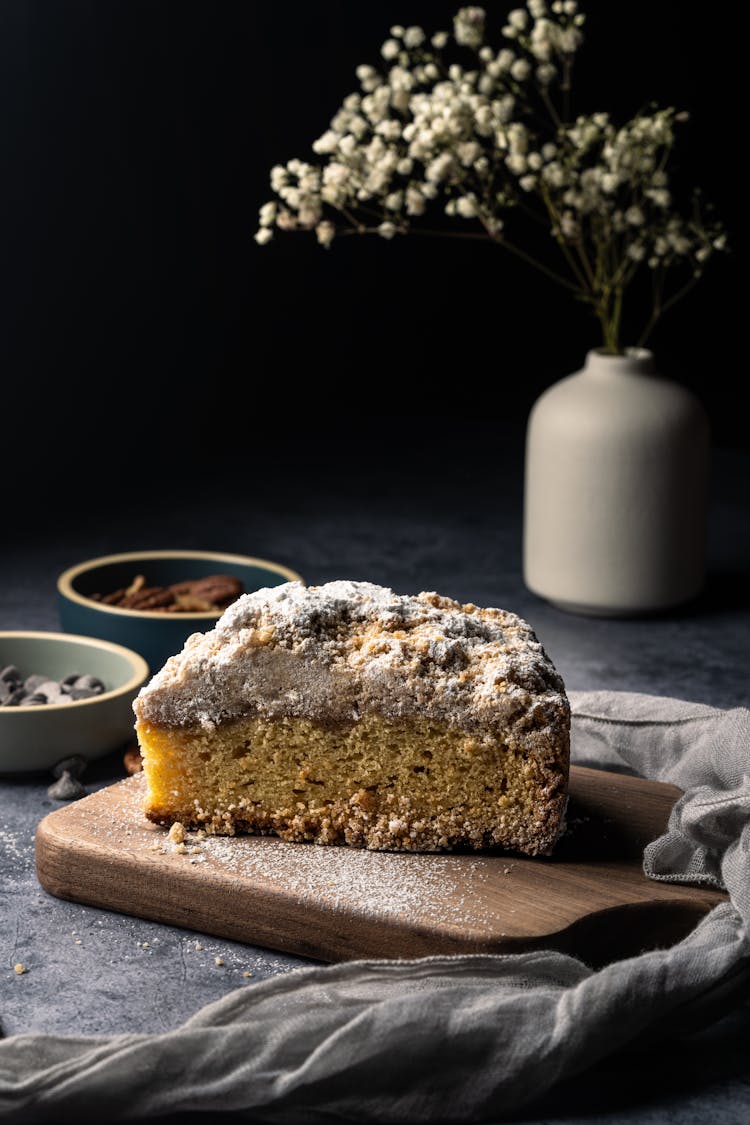 A Slice Of Crumb Cake On Wooden Board