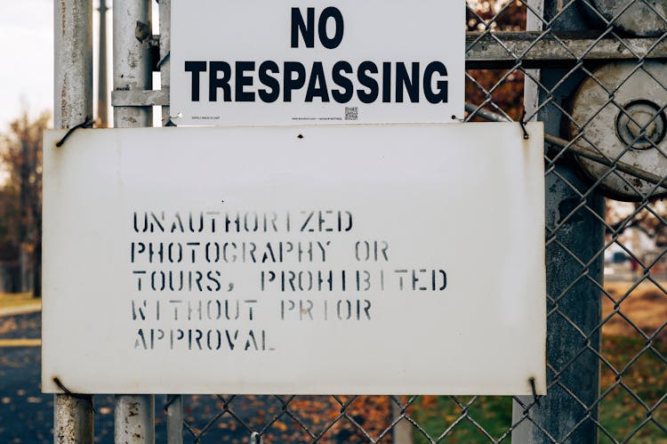 No Trespassing Sign On Wire Mesh Fence