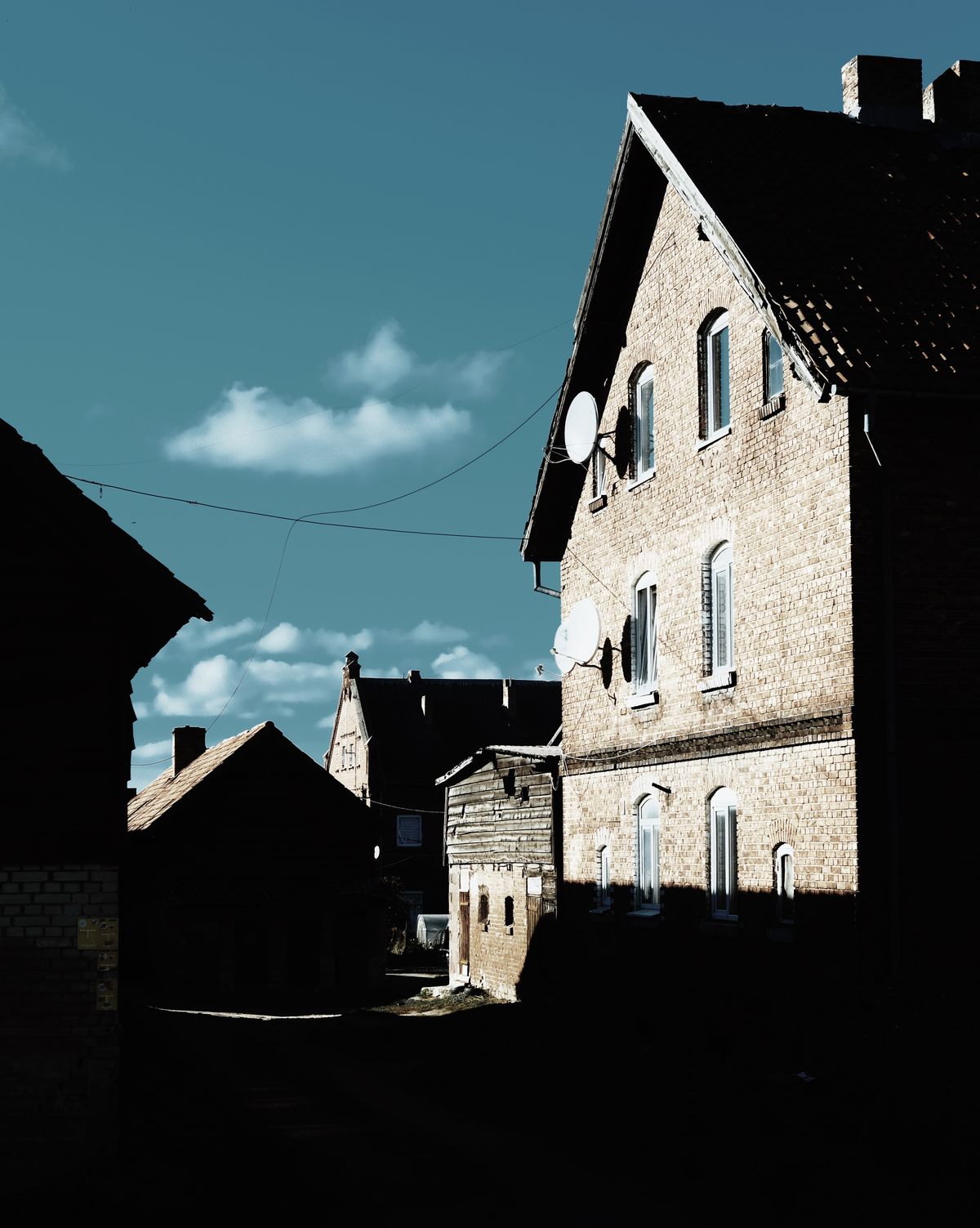 Street of old brick houses under a clear blue sky