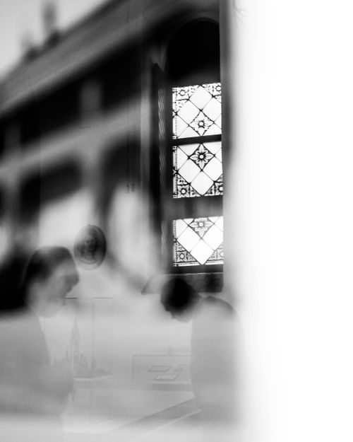 Free Blurred figures and stained glass window create a dreamy black and white scene. Stock Photo