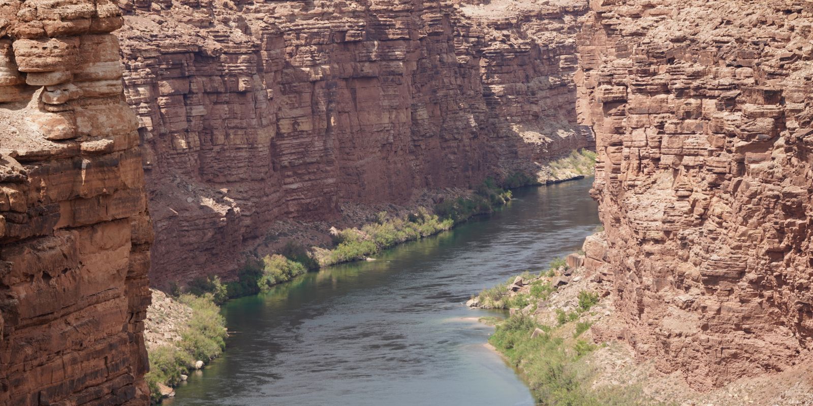 A river carving through towering rock formations in a deep canyon