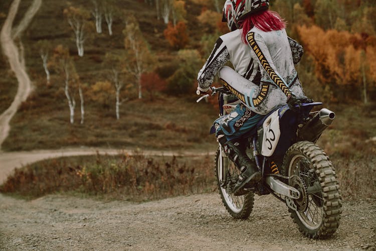 A Couple Riding A Dirt Bike