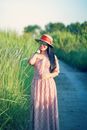 A Woman in Red and White Floral Dress Wearing Red Hat