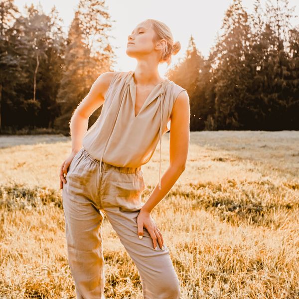 Woman in a sunlit field, photo by PabloKlik on Pexels