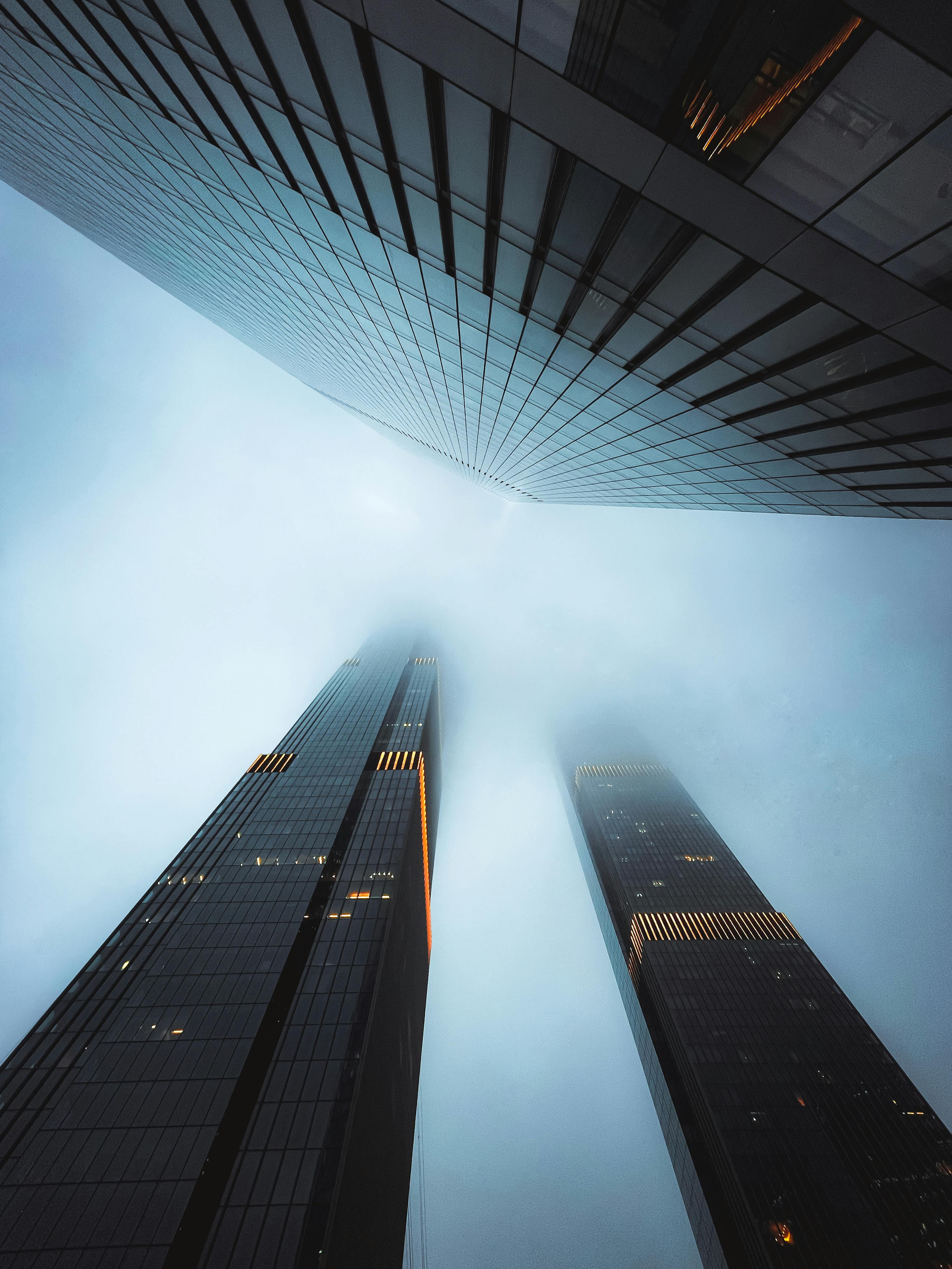 tops of city skyscrapers diminishing in smog