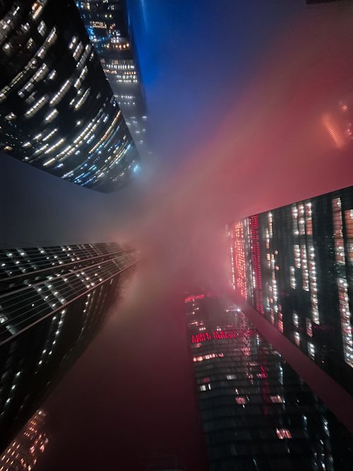 Free Dramatic night view of foggy skyscrapers in Moscow, showcasing towering architecture. Stock Photo