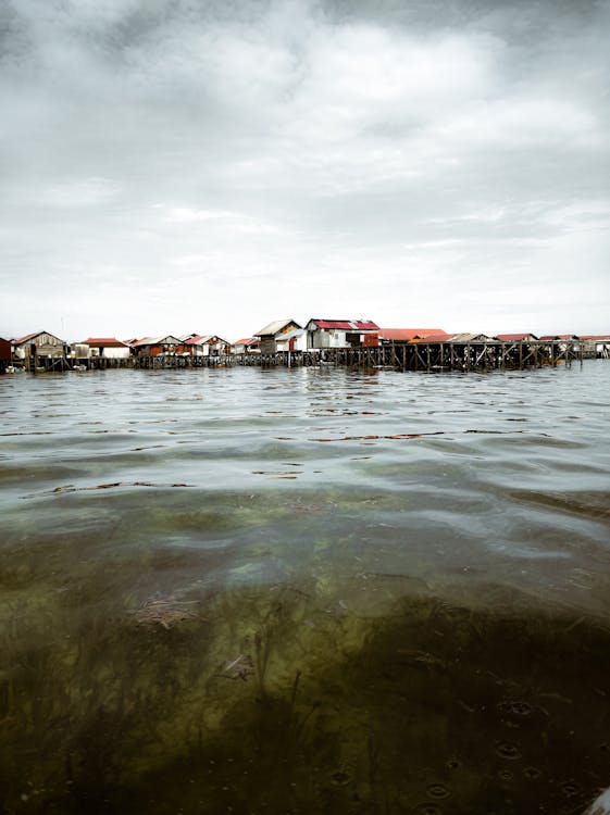 Free Photo of a Village and Jetties on Water Stock Photo