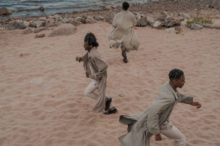 Men On Beach Running In Different Directions