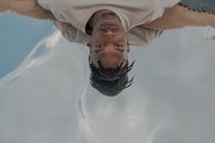 High Angle Portrait of Man Laying in Water Reflecting Sky