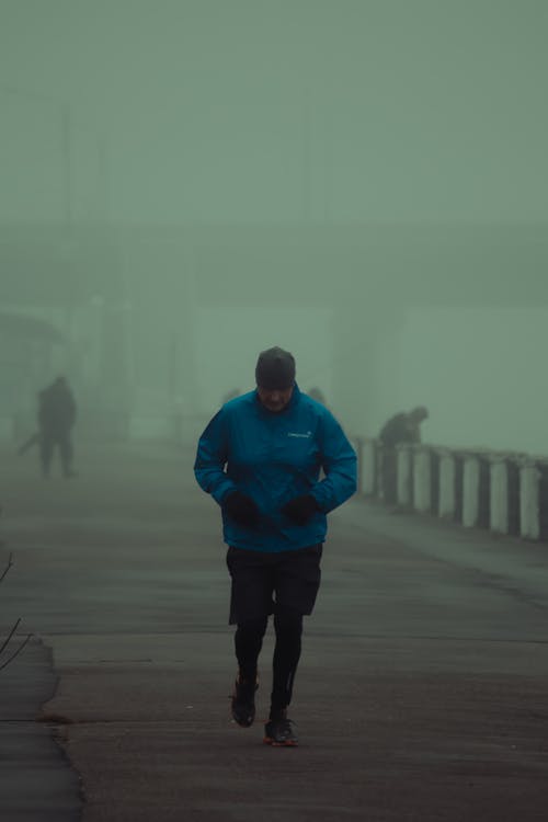 A Man Jogging in Cold Weather