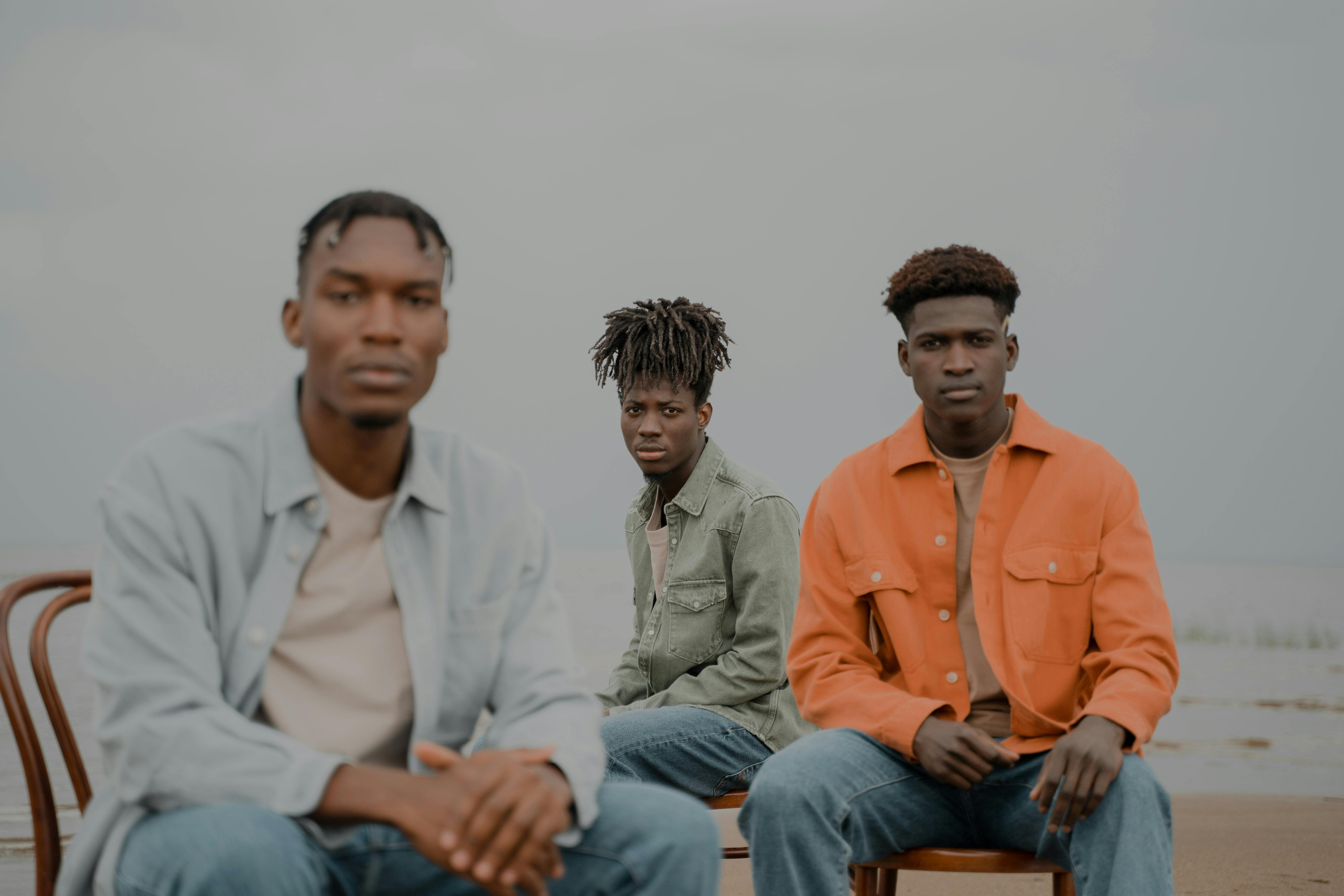 Three Men Sitting on Chairs Under Water · Free Stock Photo