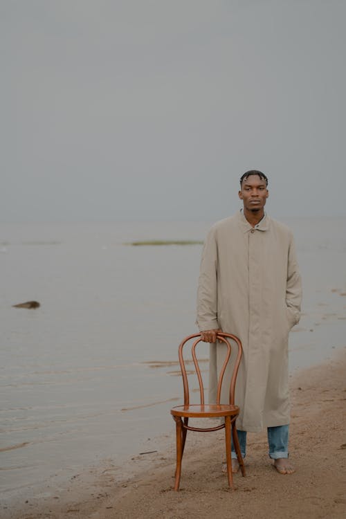 A Man in a Trench Coat at the Shore