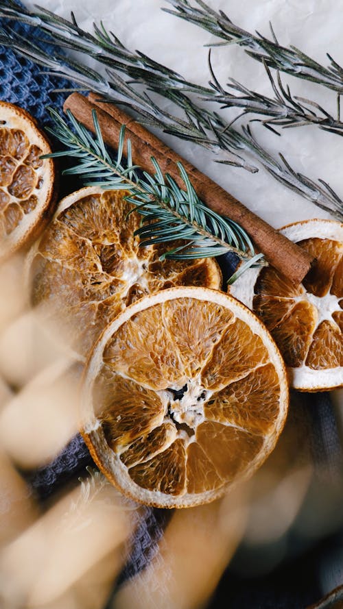 Dried Orange Slices near the Rosemary Leaves 