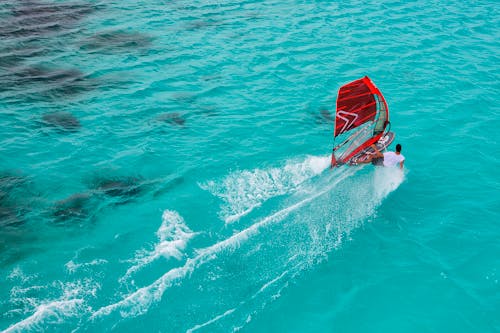 Man Windsurfing on Blue Sea