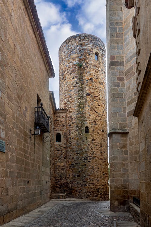 Narrow Old Town Street with Stone Wall Heritage Buildings