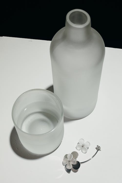 Free Clear Glass and Bottle on Table Stock Photo