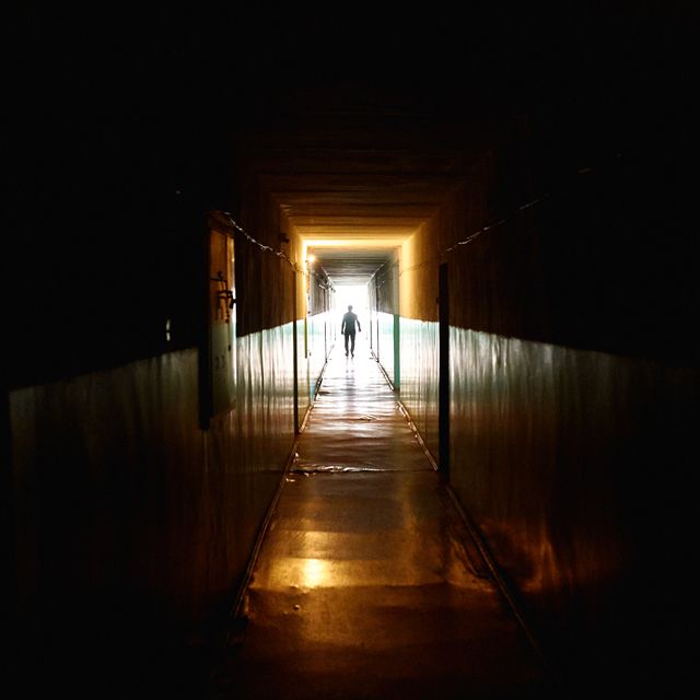 Dim interior corridor at night, photo by Dmitry Egorov on Pexels