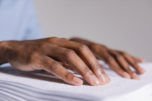 Free Hands Touching a Braille Book Stock Photo