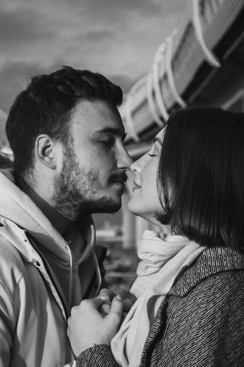 Grayscale Photo of a Man and a Woman Kissing