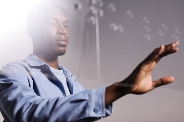 A Man Touching A Braille