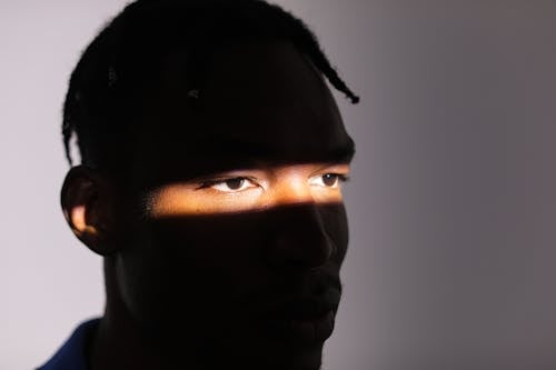 Free Sunlit Eyes of Man Face in Shadow Stock Photo