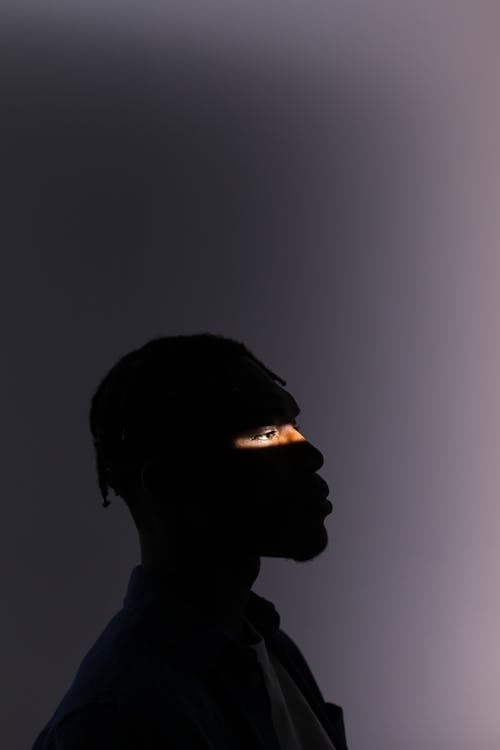 Silhouette of a Man with Natural Light Across His Eyes · Free Stock Photo