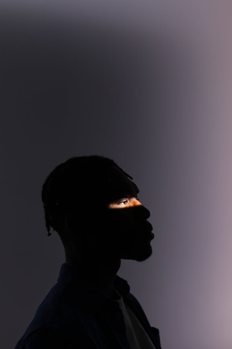 Silhouette Of A Man With Natural Light Across His Eyes