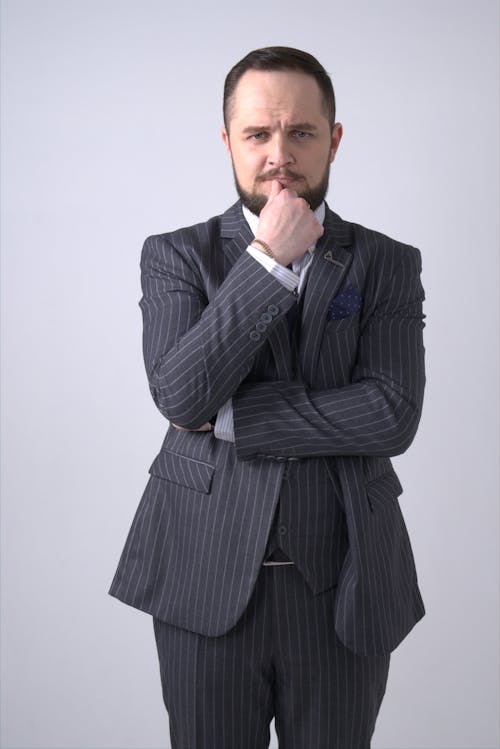 Pensive Man in Black and Gray Pinstripe Suit Jacket