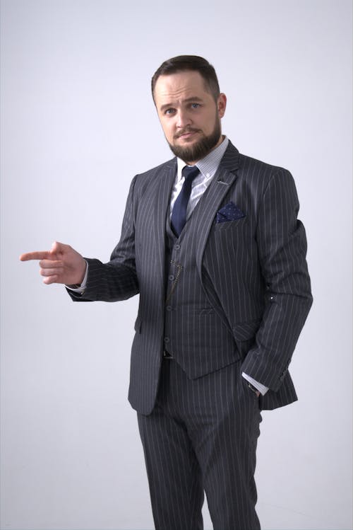 Man in Black and White Pinstripe Suit Jacket Pointing His Finger