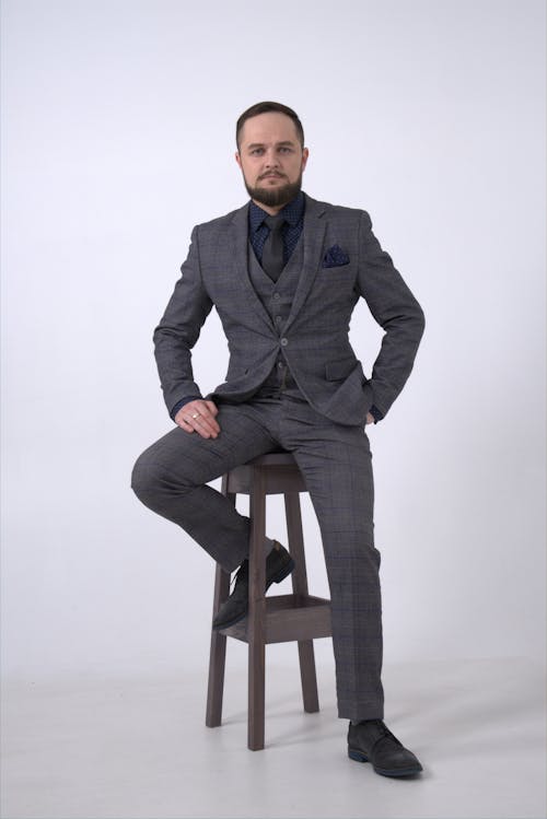 Free Man in Black Suit Sitting on Brown Wooden Stool Stock Photo
