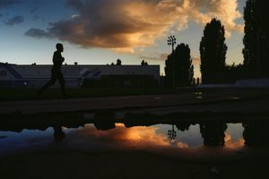 Runner silhouetted on a track at dusk — photo by Dmitry Egorov on Pexels