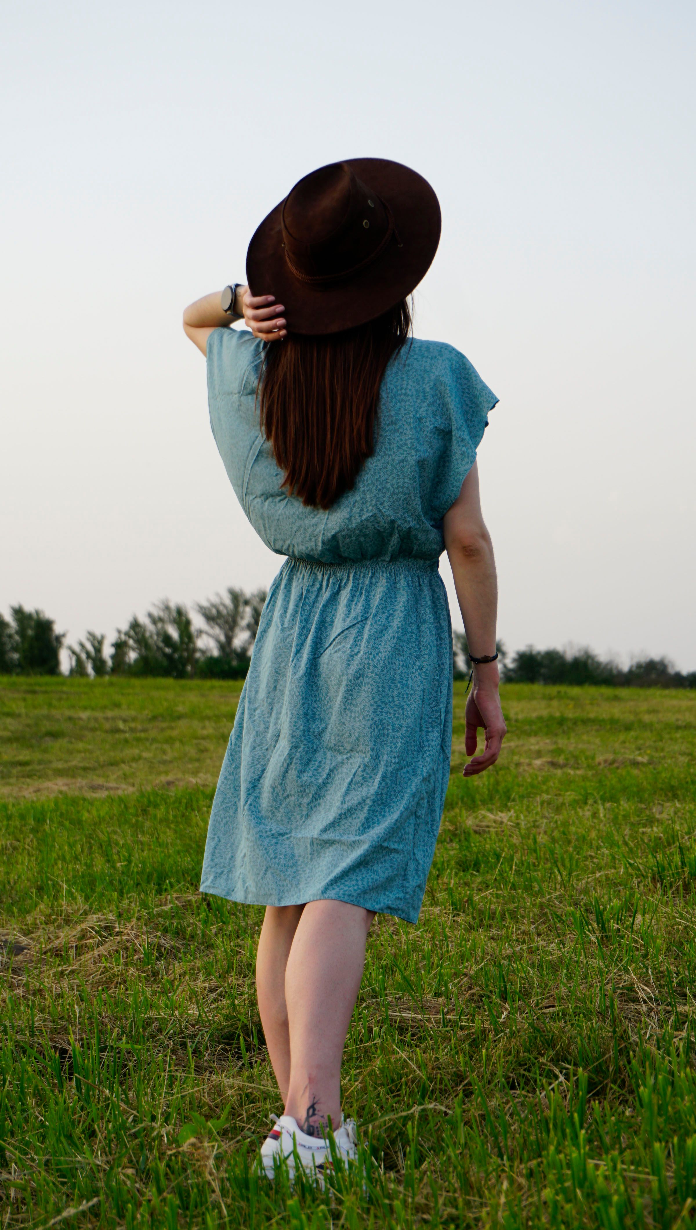 Woman in Blue Dress Standing on Green Grass Field · Free Stock Photo