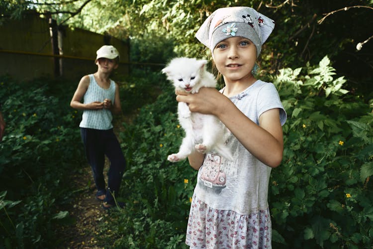 A Girl Holding Her Cute Kitten