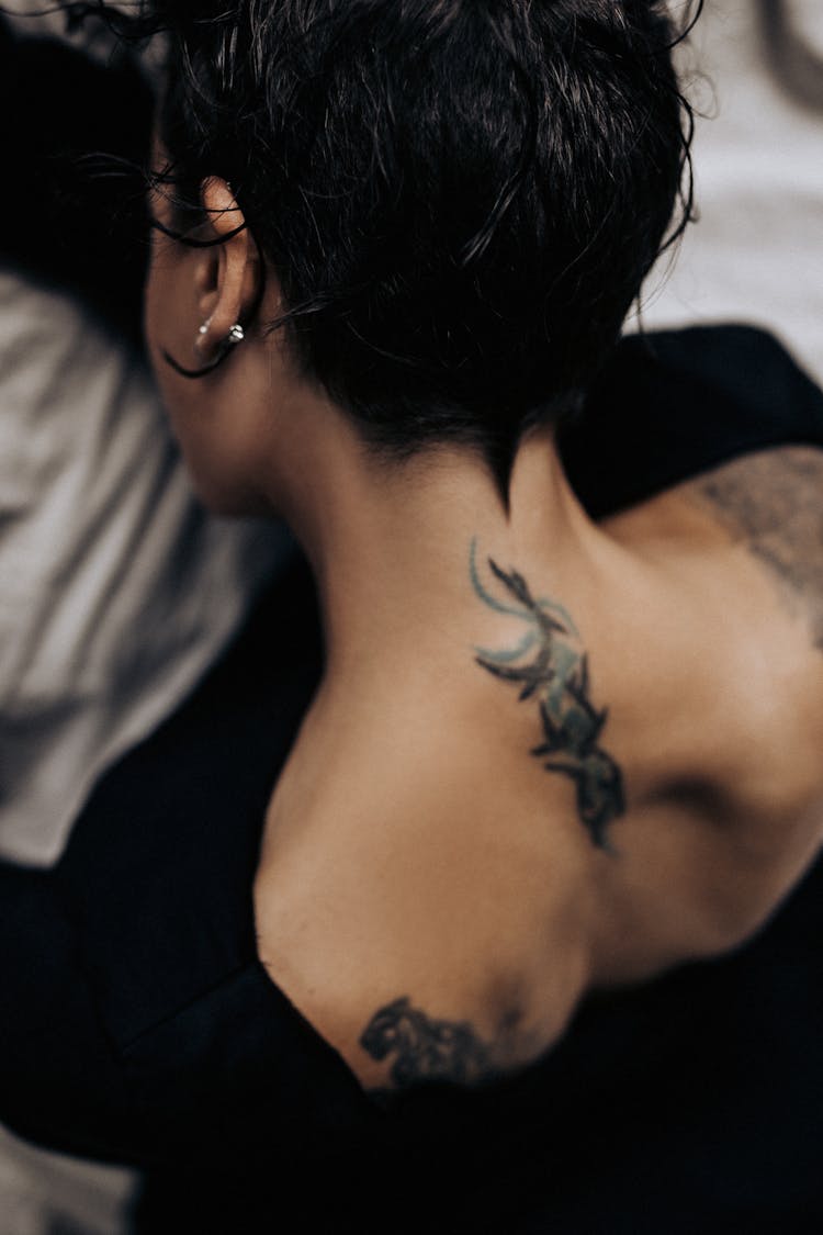 Woman With A Tattoo On Her Neck 