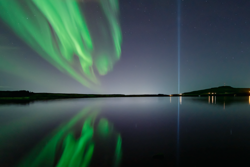 Free Captivating aurora borealis reflecting over the serene lake in Iceland at night. Stock Photo