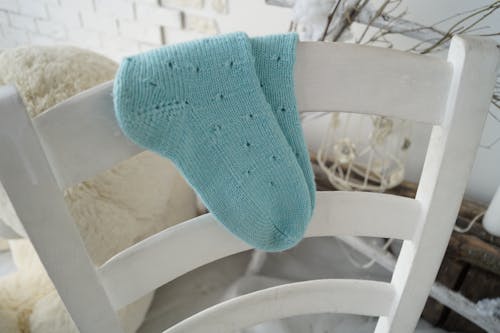 Free Blue Knit Socks on White Wooden Chair Stock Photo