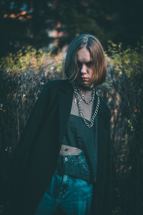 Free Woman in Black Coat Standing Near Green Plants Stock Photo