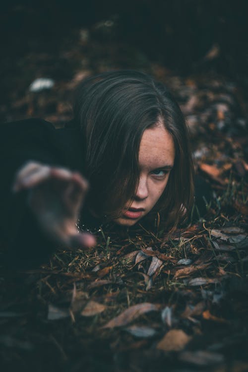 Woman on Ground with Brown Dried Leaves