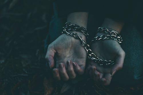 A Person Wearing Silver Chain Bracelets